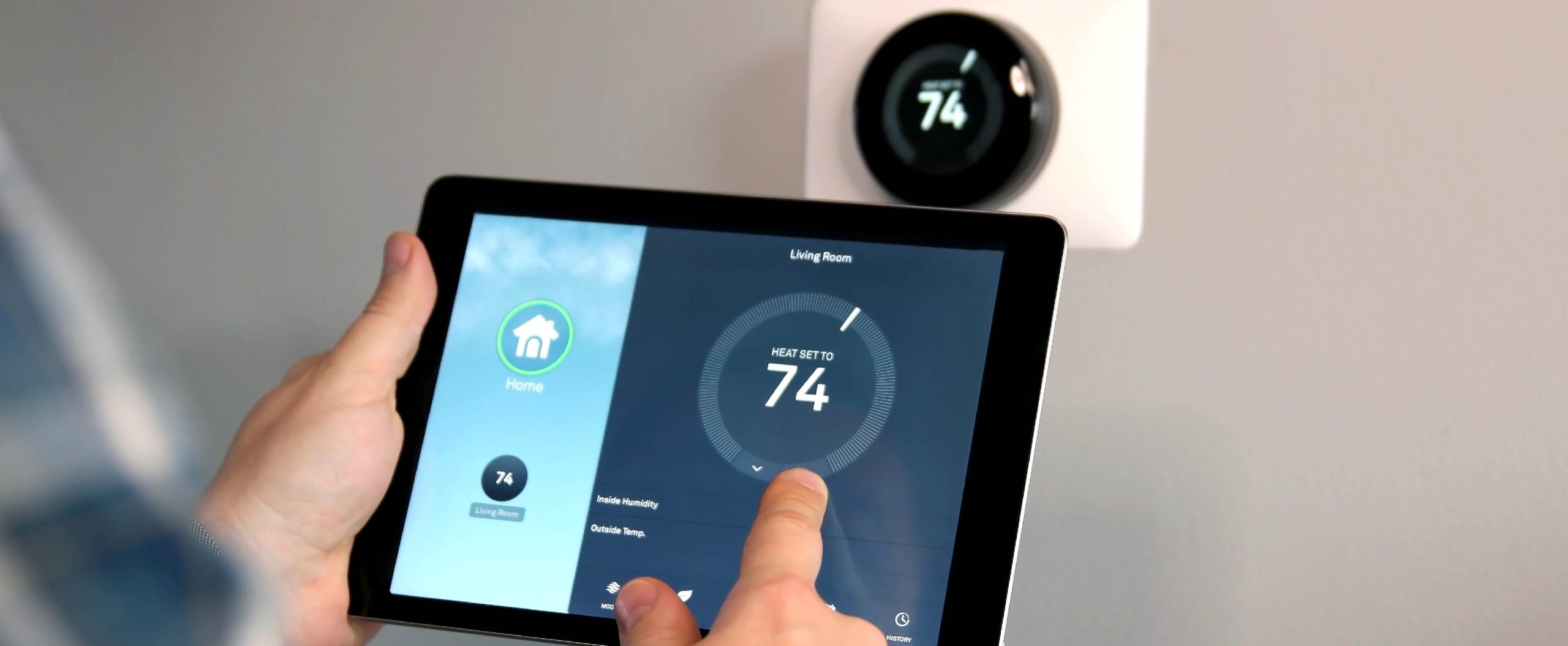 person using touch screen thermostat to adjust home heating