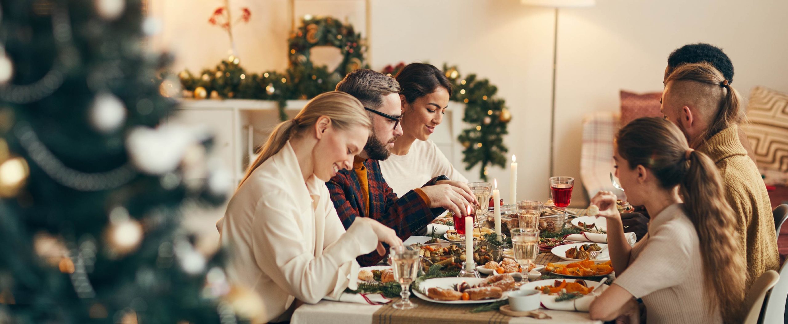 family eating a meal together at festive table